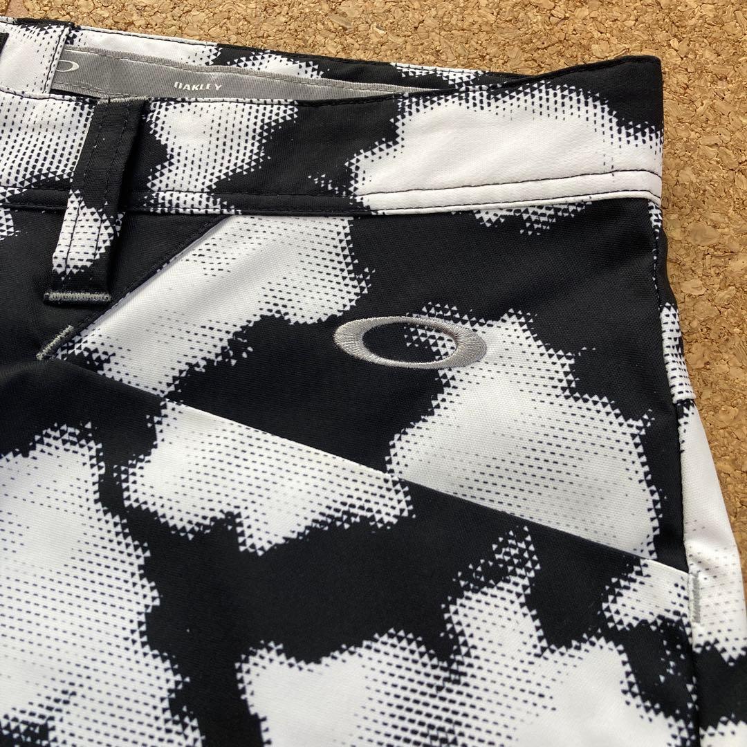 【美品】オークリーOAKLEYゴルフウェア パンツサイズ36メンズ白黒柄撥水春夏